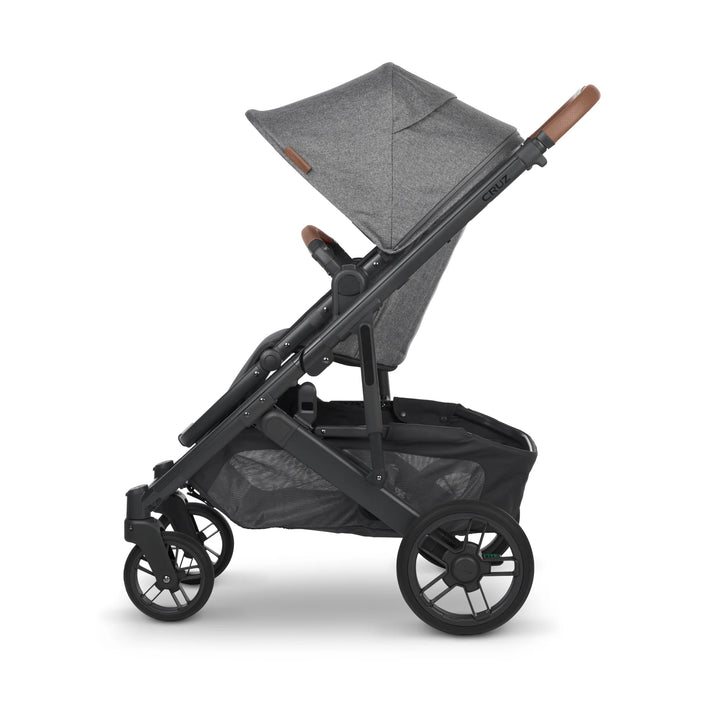 Side view of UPPAbaby Cruz V2 Greyson stroller in grey – modern lightweight pushchair with leather handlebar, adjustable seat recline, and spacious storage basket for everyday family travel