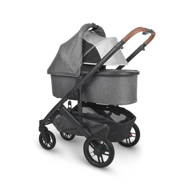 UPPAbaby Cruz V2 Greyson stroller with bassinet – premium grey travel system featuring leather handlebar, ventilated canopy, and large storage basket for newborn comfort and style.