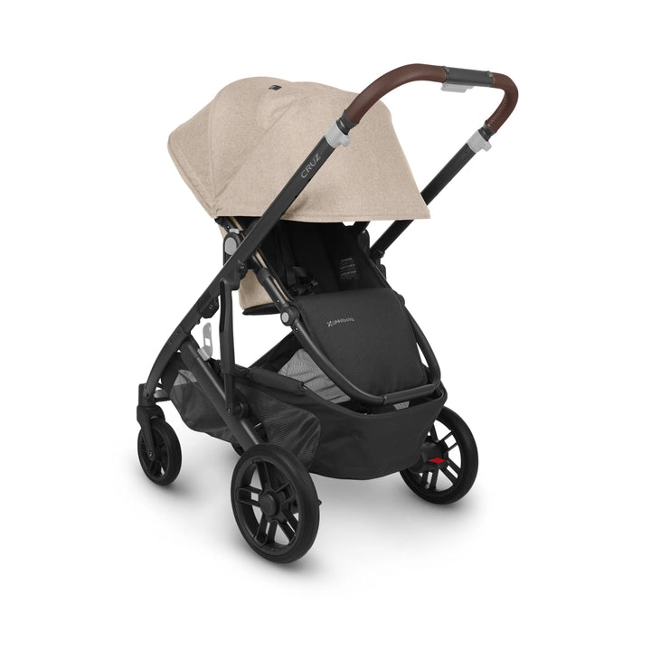 UPPAbaby Cruz V2 Liam stroller – premium beige pushchair with leather handlebar, adjustable canopy, and large under-seat storage basket for modern family adventures.