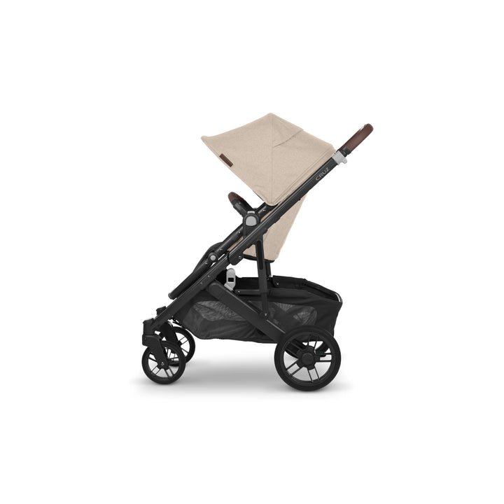 UPPAbaby Cruz V2 Liam stroller side view – beige premium pushchair with leather handlebar, adjustable canopy, and spacious under-seat basket for stylish everyday travel.