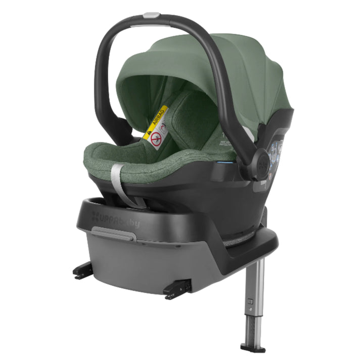 UPPAbaby MESA i-Size infant car seat in green securely attached to ISOFIX base with stability leg, demonstrating rear-facing newborn travel system installation