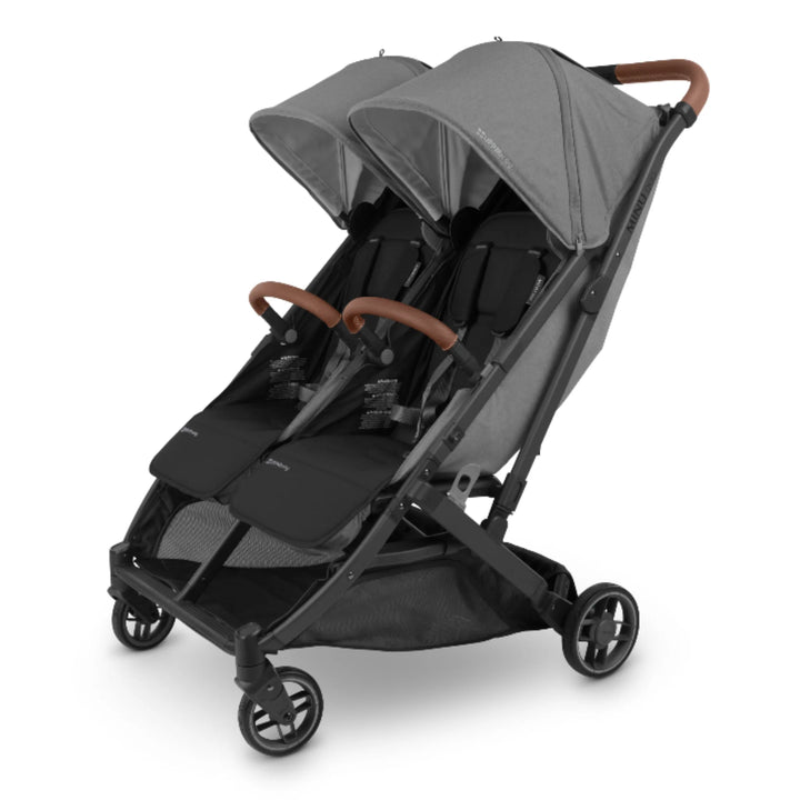 UPPAbaby MINU Duo double stroller angled view in grey with saddle leather bumper bars and canopy on white background