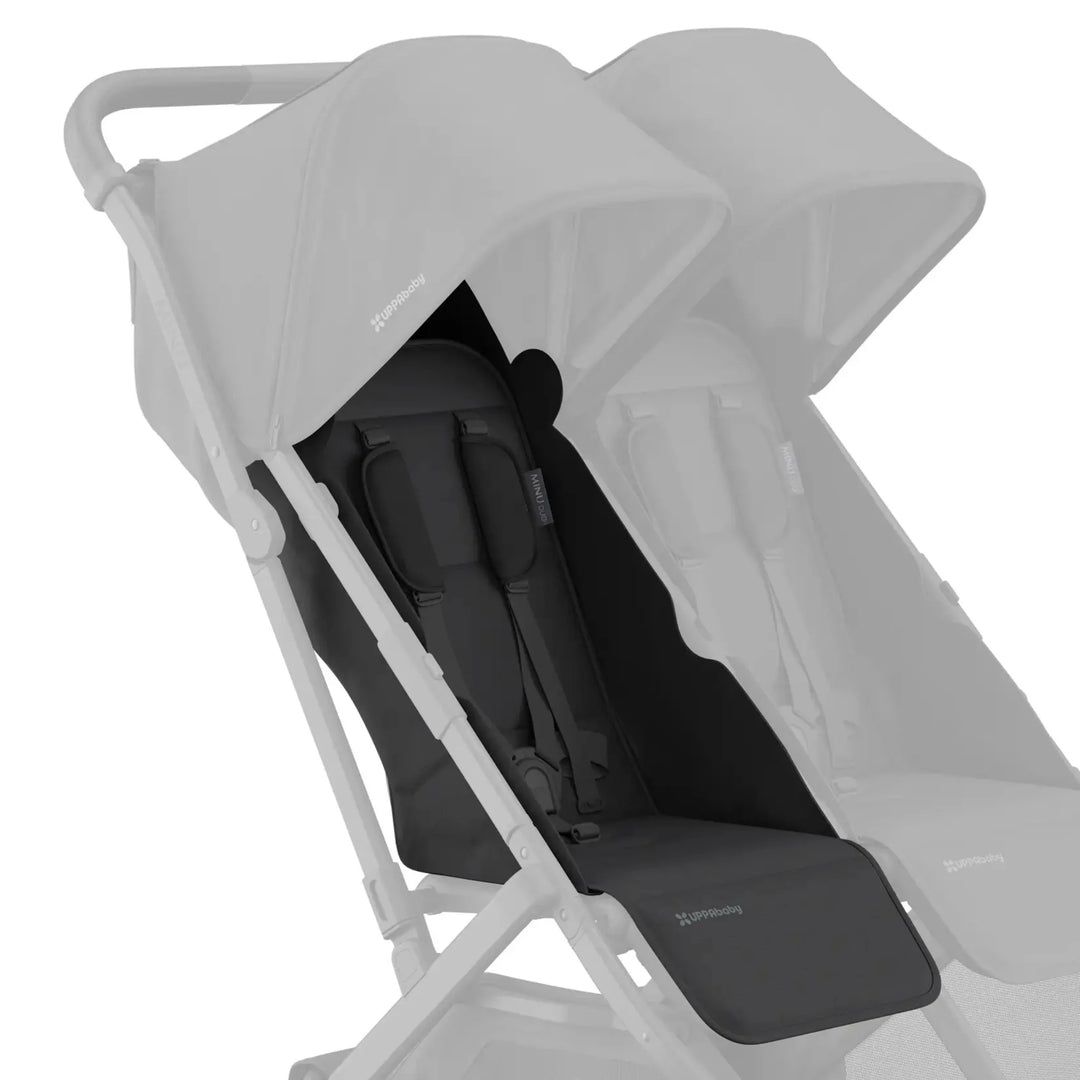 UPPAbaby Minu Duo stroller with black (Jake) replacement seat fabric installed on the left seat, with the opposite seat faded on a white background.
