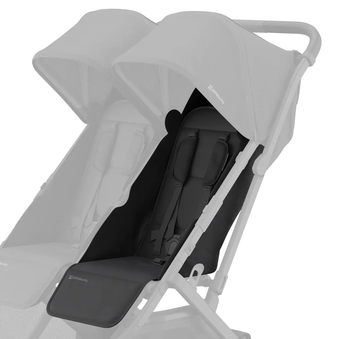 UPPAbaby Minu Duo stroller with black (Jake) replacement seat fabric installed on the right seat, with the opposite seat faded on a white background.
