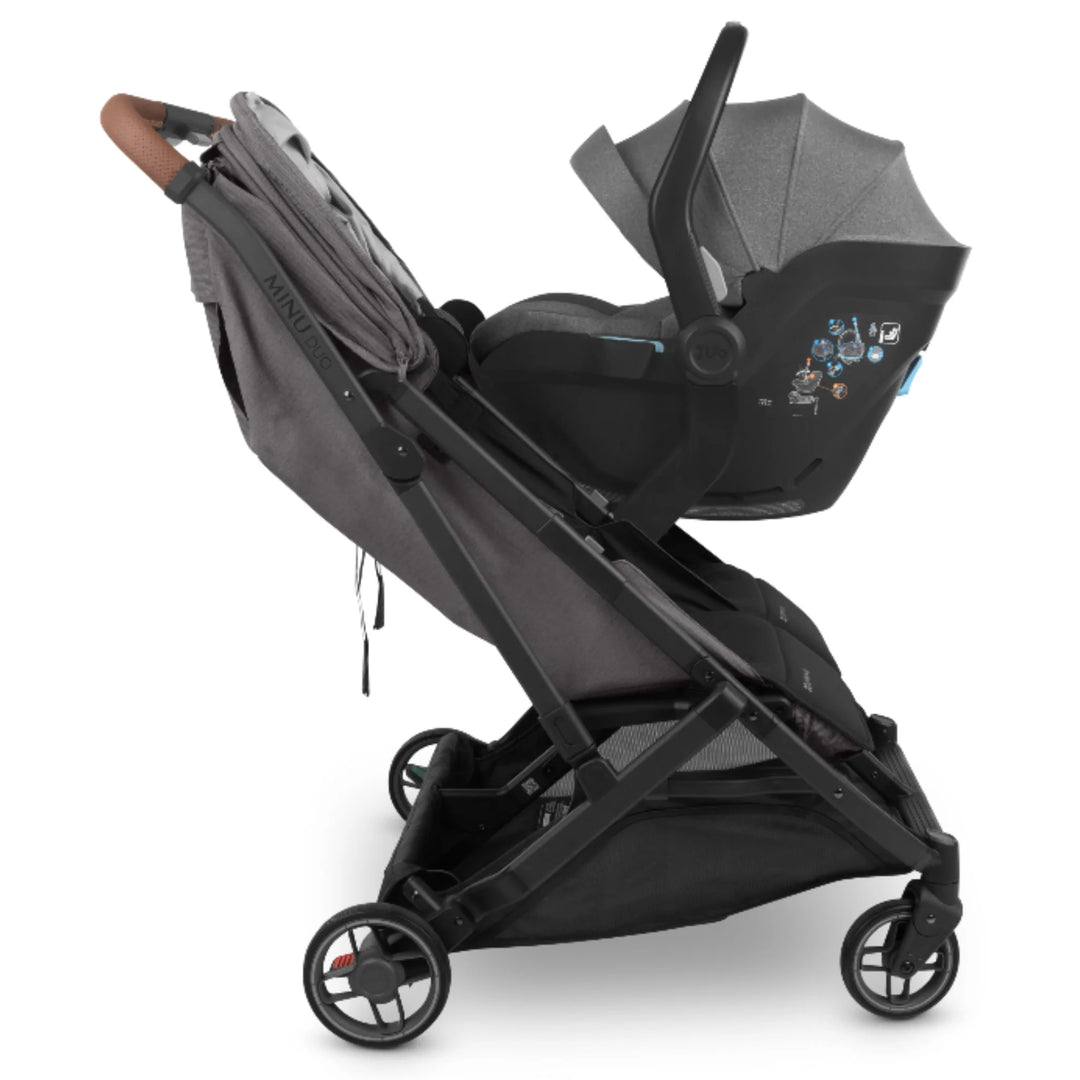 UPPAbaby MINU Duo stroller with MESA infant car seat attached using car seat adapters, side view on white background