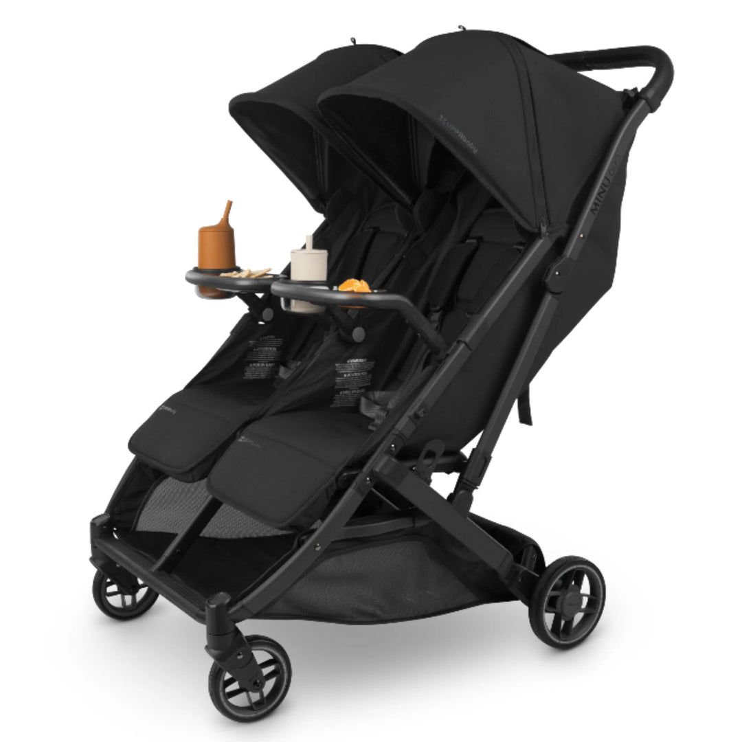 UPPAbaby Minu Duo Jake black double stroller with snack tray accessory and cup holder attached, angled view on white background