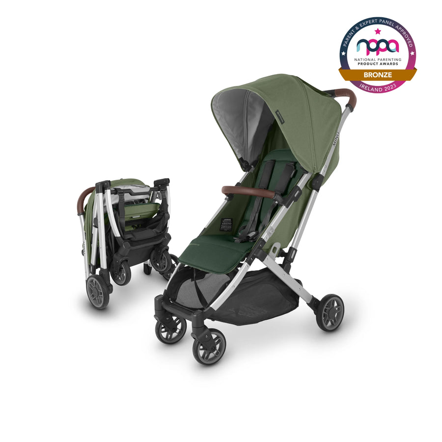 UPPAbaby Minu V2 lightweight travel stroller in Emelia which is a green fabric with chestnut REACH certified leather accents on a silver frame. An image of the small footprint of the folded stroller is to the left of the un-folded stroller image. The NPPA Bronze logo for 2023 is in the top right hand corner.