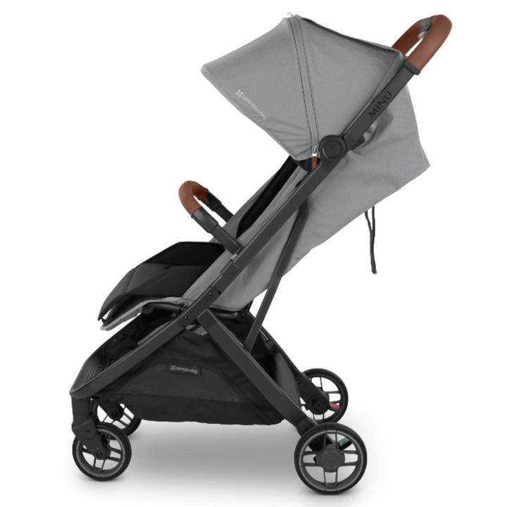 UPPAbaby MINU V3 stroller, side view, with Saddle (brown) bumper bar, on a white background.