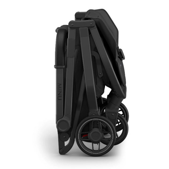 “UPPAbaby MINU V3 stroller folded in Jake black, compact lightweight travel stroller on white background”