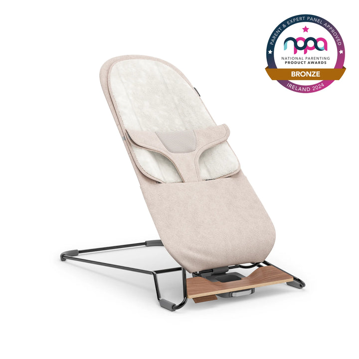 UPPAbaby baby bouncer in beige colour with bronze NPPA logo on white background.