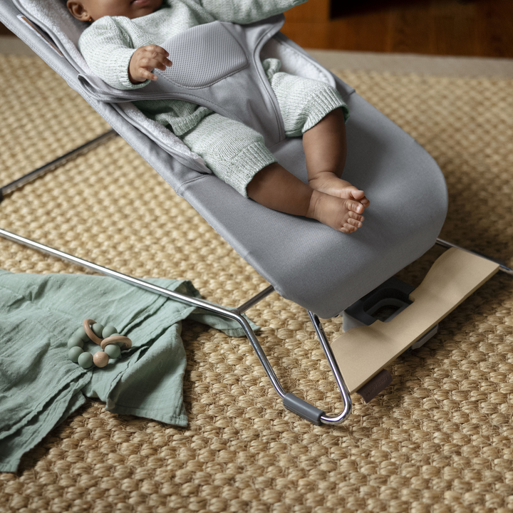 This is a lifestyle shot of a baby lounging in the Stella fashion of the Mira bouncer.