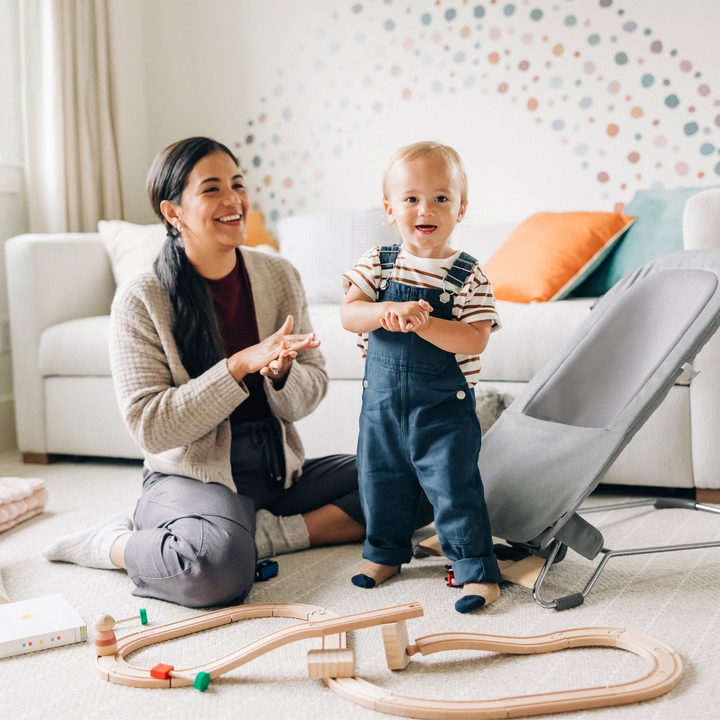 This is a lifestyle image of the Mira bouncer in the toddler seat mode in a nursery