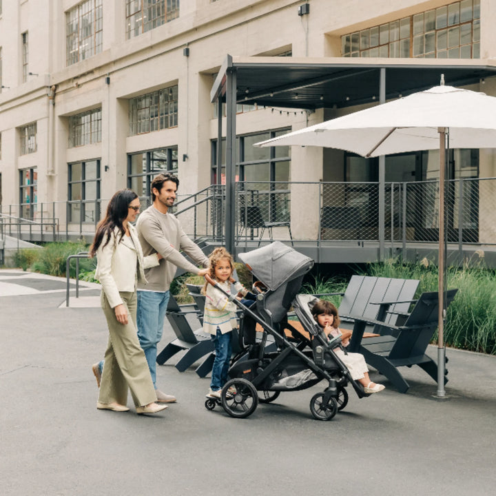 “UPPAbaby Vista V3 stroller with RumbleSeat and PiggyBack ride-along board, family strolling with two kids”