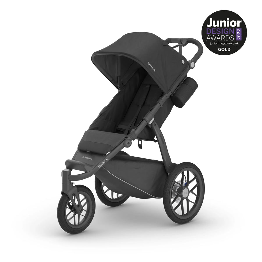UPPAbaby Ridge active jogging stroller in Jake with a charcoal fabric and carbon frame with foam handlebars. The Ridge has a hand brake, wrist strap and large wheels, making it perfect for active parents.
