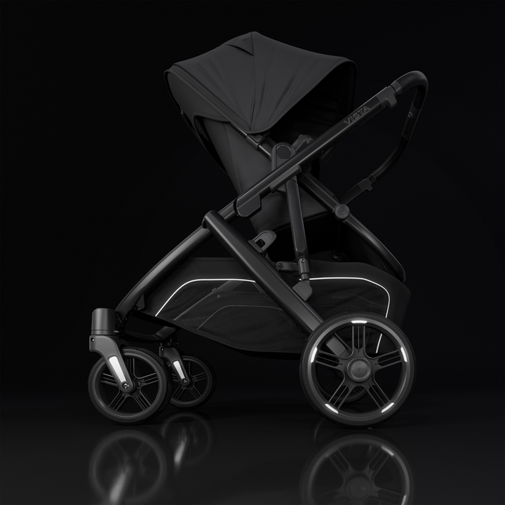 This image shows the Vista V3 in Jake on a black background highlighting the new reflective accents on the wheels and basket.