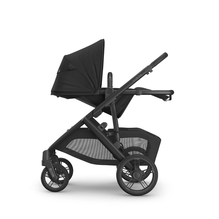 UPPAbaby Vista V3 Jake stroller in black shown in fully reclined toddler seat position, side profile view with extended sun canopy, adjustable frame, large underseat storage basket, and all-terrain wheels.
