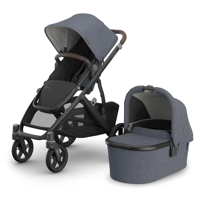 UPPAbaby Vista V3 stroller in Jullian blue with toddler seat and matching newborn bassinet shown side-by-side on a white background, highlighting the premium travel system's versatile design, durable frame, large wheels and stylish blue canopy fabric.