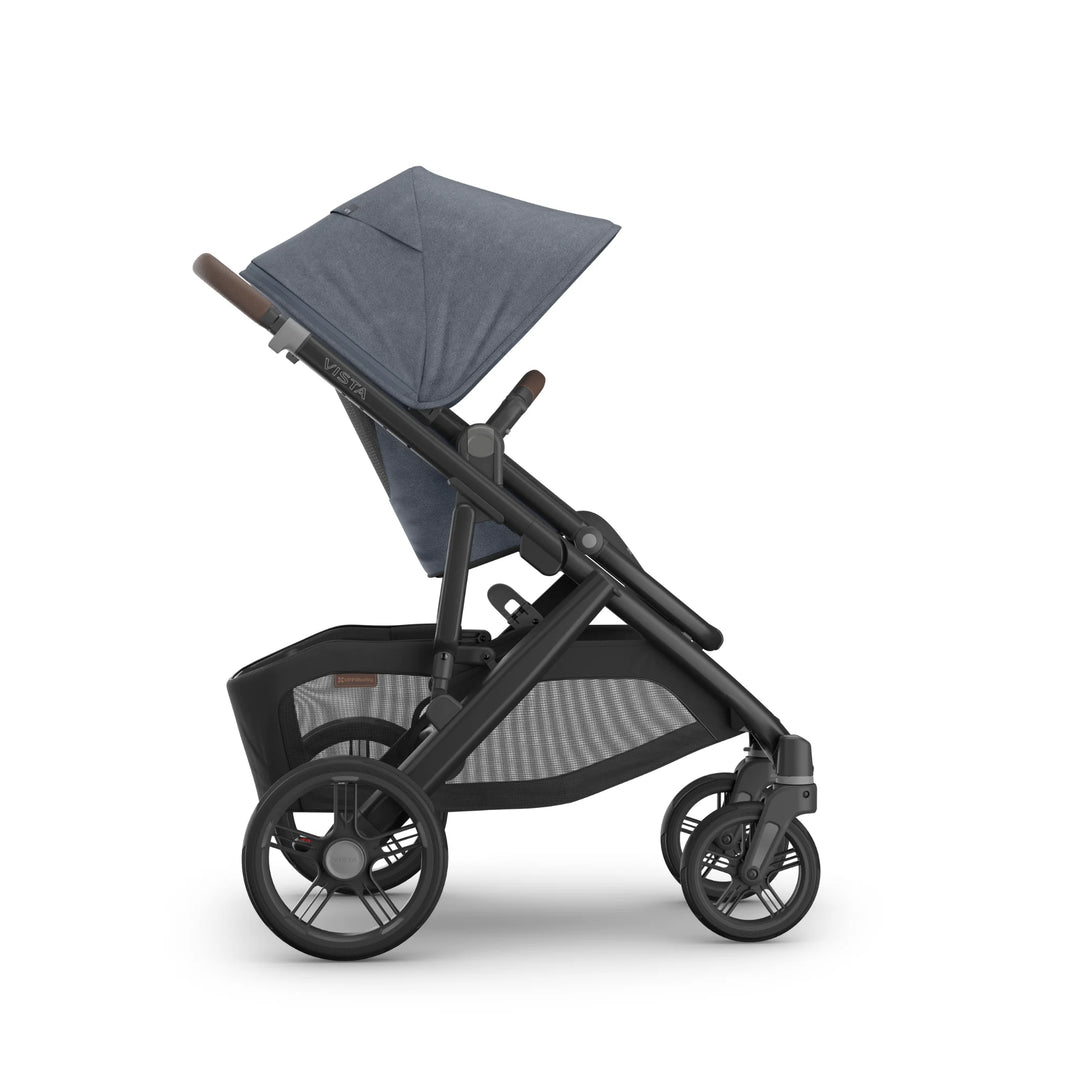 Side view of the UPPAbaby Vista V3 stroller in Jullian blue, highlighting the forward-facing toddler seat, extendable canopy, adjustable handlebar, large all-terrain wheels and oversized storage basket on the premium Vista travel system.