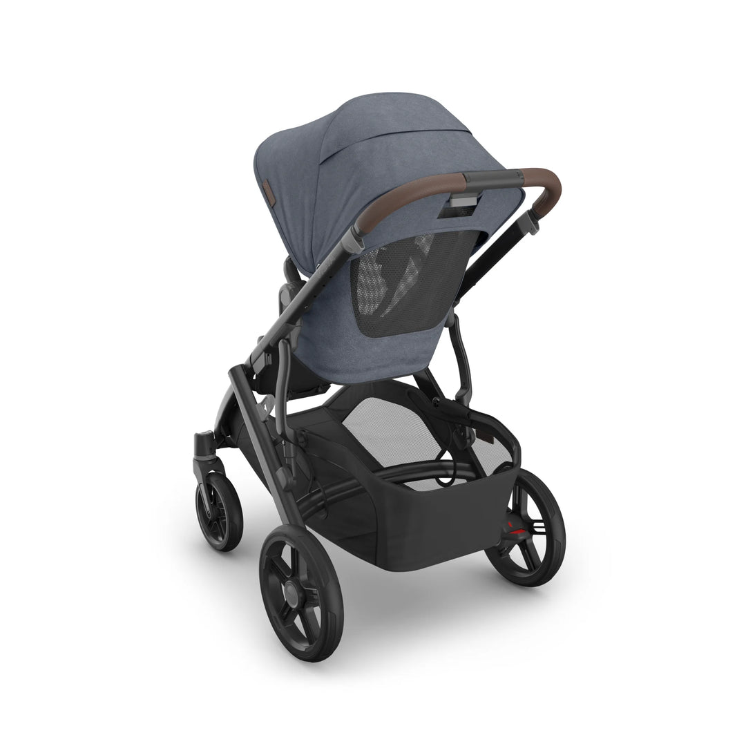 Rear angled view of the UPPAbaby Vista V3 stroller in Jullian blue, showcasing the ventilated toddler seat canopy, leather push handle, large all-terrain wheels and spacious under-seat storage basket on the premium Vista travel system.