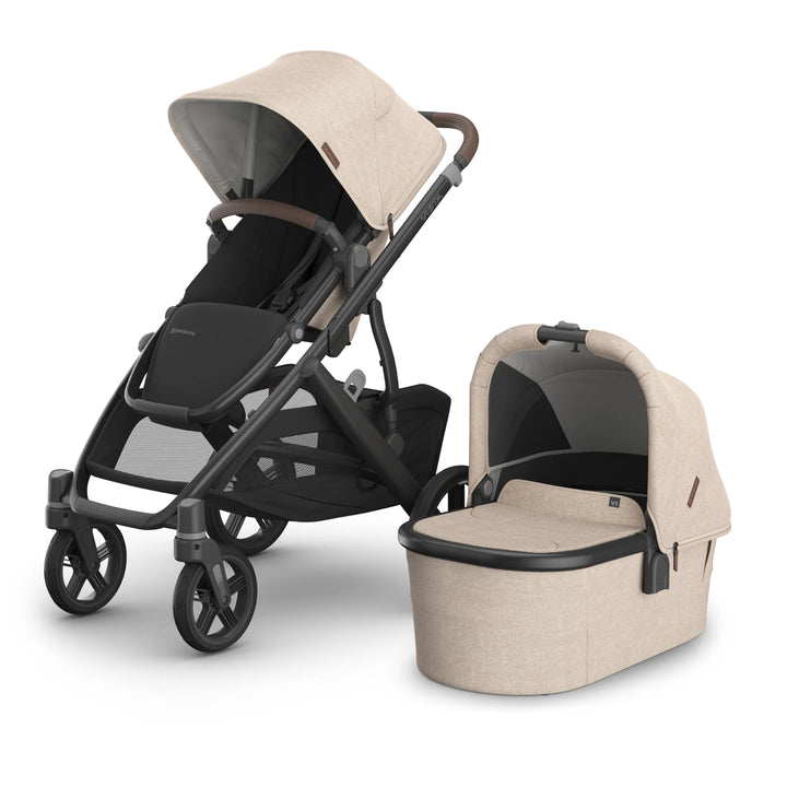 UPPAbaby Vista V3 stroller and matching carrycot in the Liam oatmeal colourway, showcasing the premium leather-accented handlebar, spacious seat, large extendable canopy, durable frame and newborn-ready bassinet.