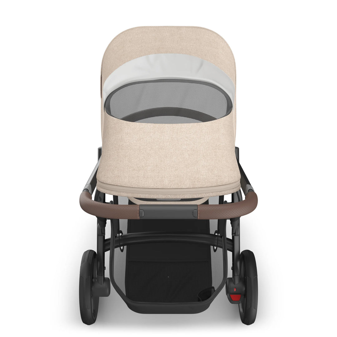 Front view of the UPPAbaby Vista V3 stroller in the Liam oatmeal colourway showing the peek-a-boo mesh window on the extended canopy, premium fabric design, leather-accented handlebar and sturdy all-terrain frame.