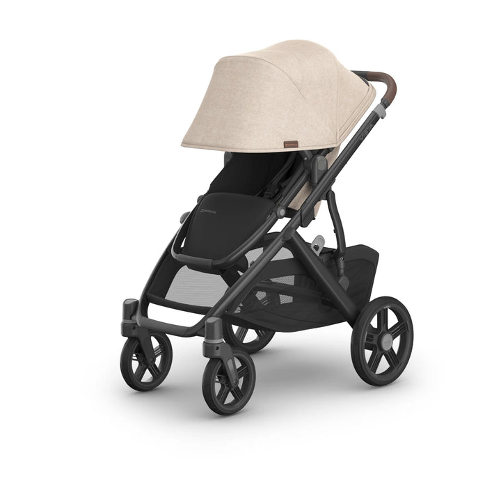 UPPAbaby Vista V3 stroller in the Liam oatmeal colourway with sunshade fully extended, featuring premium fabric canopy, leather-accented handlebar, all-terrain wheels, spacious seat and large under-seat storage basket.