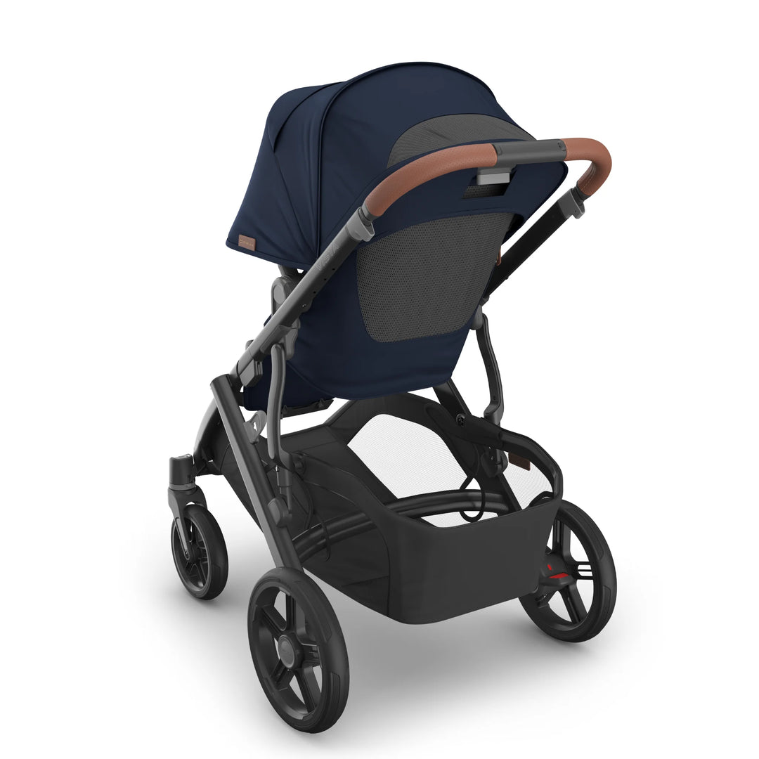 Rear view of the UPPAbaby Vista V3 stroller in the Noa navy blue colourway, showing the breathable mesh canopy panel, leather-accented handlebar, sturdy all-terrain wheels and extra-large under-seat storage basket.