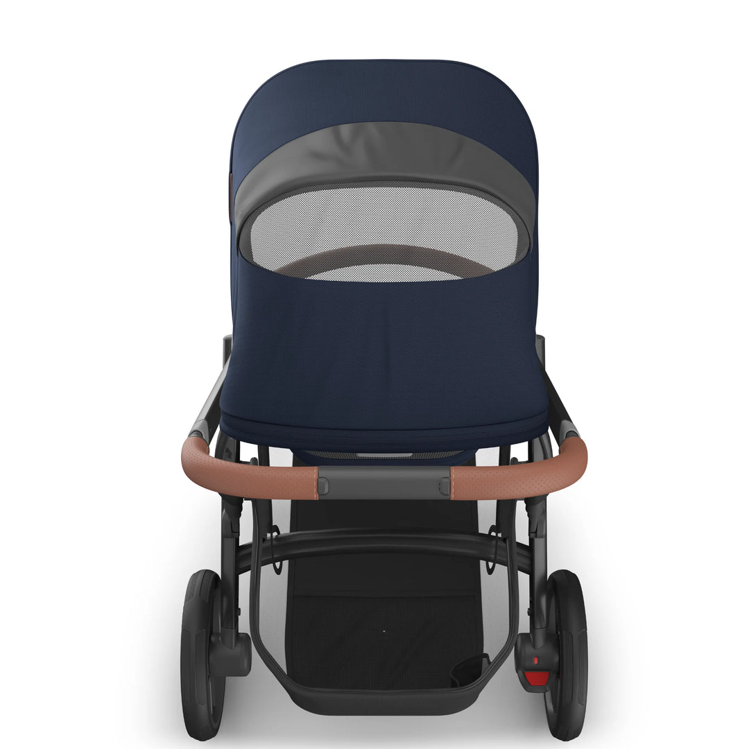 Rear view of the UPPAbaby Vista V3 stroller in the Noa navy blue colourway showing the peekaboo mesh ventilation window, premium leather-accented handlebar, sturdy all-terrain wheels and extra-large under-seat storage basket.