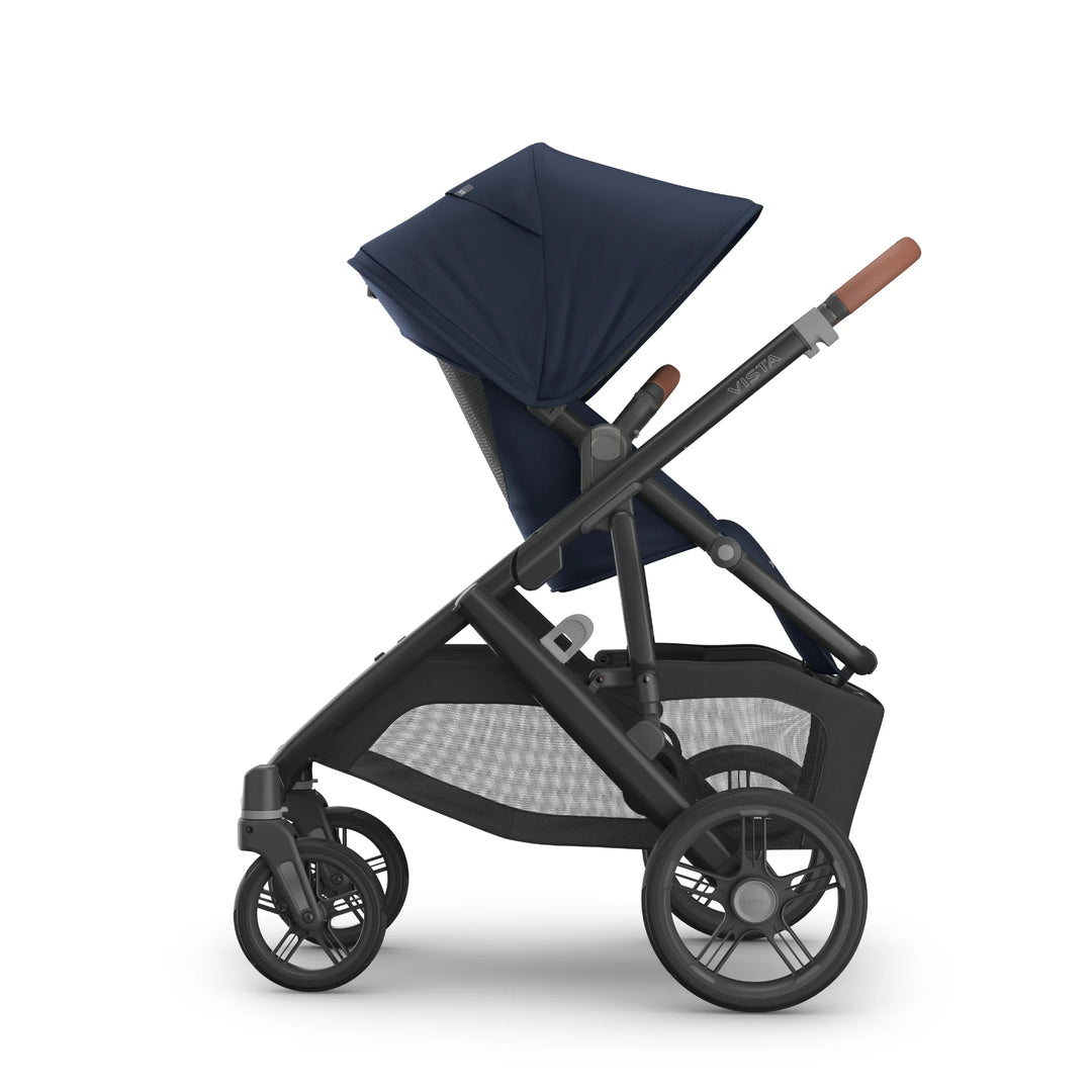 Side view of the UPPAbaby Vista V3 stroller in the Noa navy blue colourway with the toddler seat upright, featuring the extendable canopy, ergonomic seat design, leather-accented handlebar, durable all-terrain wheels and spacious under-seat storage basket.