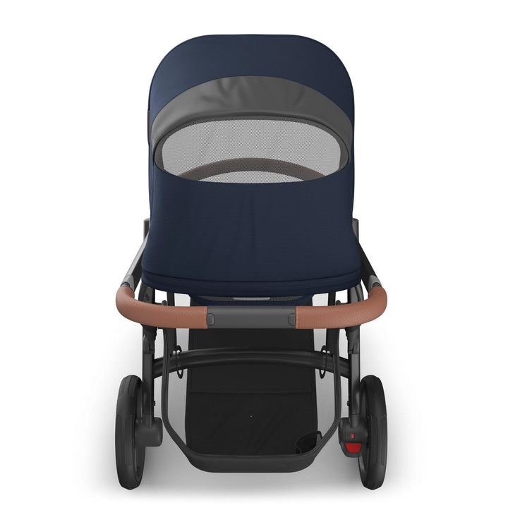 Rear view of the UPPAbaby Vista V3 stroller in the Noa navy blue colourway showing the peekaboo mesh ventilation window on the extended canopy, premium leather-accented handlebar, sturdy frame and spacious under-seat storage basket.