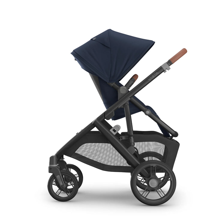 Side view of the UPPAbaby Vista V3 stroller in the Noa navy blue colourway, featuring the extended canopy, ergonomic toddler seat, adjustable leather-accented handlebar, large under-seat storage basket and durable all-terrain wheels.