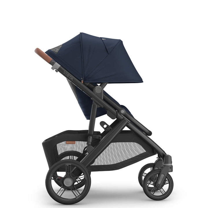 Side view of the UPPAbaby Vista V3 stroller in the Noa navy blue colourway with the toddler seat upright, highlighting the extended canopy, ergonomic seat design, leather-accented handlebar, durable all-terrain wheels and extra-large under-seat storage basket.