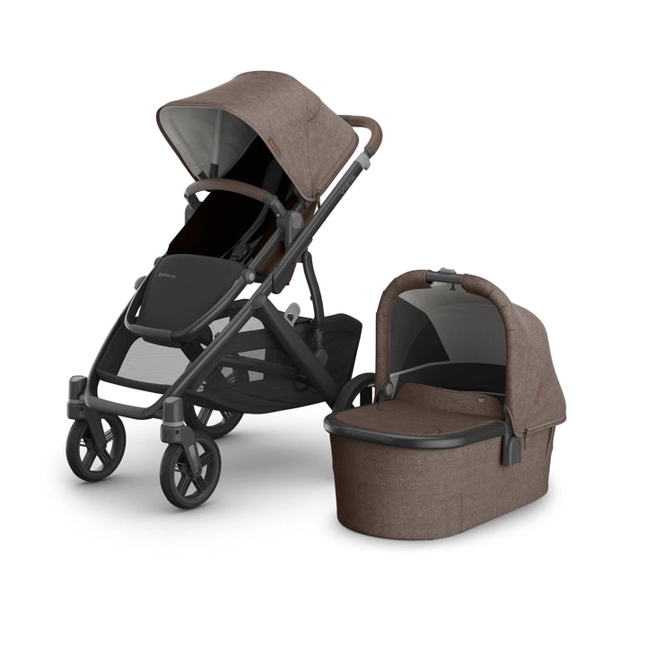 UPPAbaby Vista V3 stroller and matching newborn bassinet in Owen, a warm brown textured fabric, shown in a studio product image featuring the toddler seat with extendable canopy, leather accents, durable all-terrain wheels and spacious under-seat storage on the premium Vista travel system