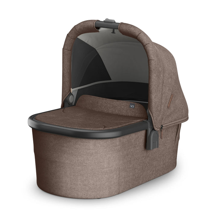 UPPAbaby Vista V3 Owen bassinet in brown fabric featuring a ventilated mesh panel, extendable canopy, padded mattress insert, and sleek black trim, displayed on a white background