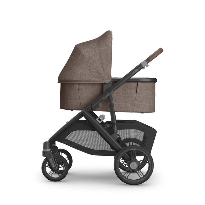 UPPAbaby Vista V3 stroller in Owen fabric with attached matching bassinet, shown in side profile featuring the brown textured canopy, ventilated bassinet panel, leather-accented handlebar, large all-terrain wheels and oversized under-seat storage basket.