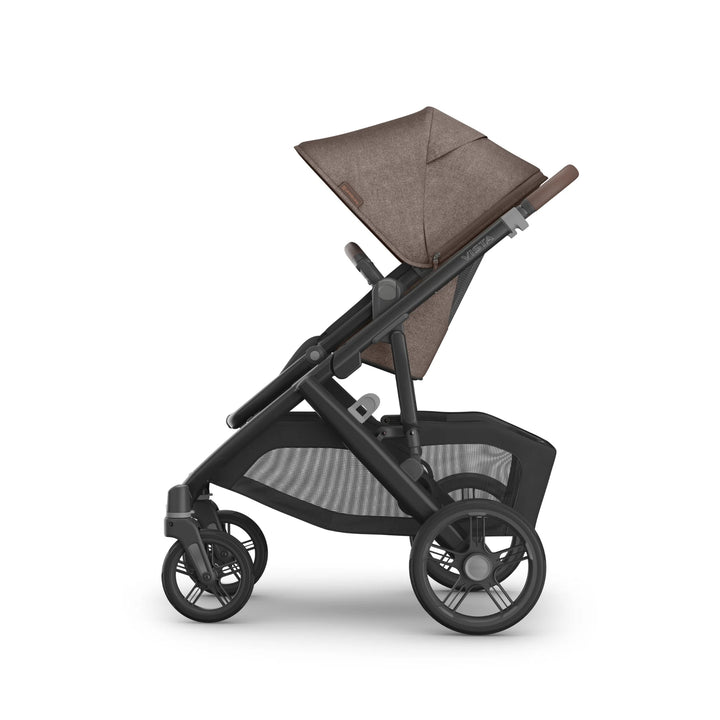 Side view of the UPPAbaby Vista V3 stroller in Owen, featuring the brown textured canopy, forward-facing toddler seat, adjustable handlebar, large all-terrain wheels and spacious mesh storage basket on the premium Vista travel system.