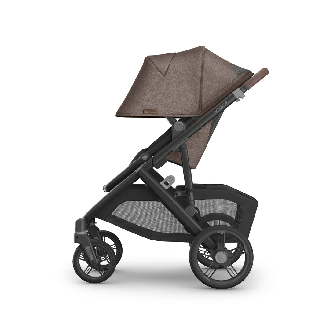 UPPAbaby Vista V3 stroller in Owen, shown in a side profile with the toddler seat fully upright and canopy extended, featuring the brown textured fabric, adjustable leather-accented handlebar, large all-terrain wheels and spacious mesh under-seat basket on the premium Vista travel system.