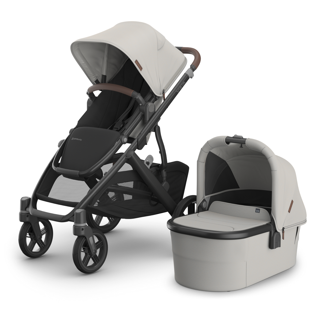 This image shows the Vista V3 in Savannah with the Carrycot V3 alongside it.