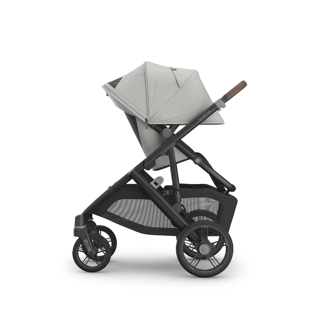 UPPAbaby Vista V3 Savannah stroller side view featuring light grey toddler seat fully extended canopy, adjustable recline, large all-terrain wheels, leather handlebar, and oversized storage basket on premium charcoal frame.