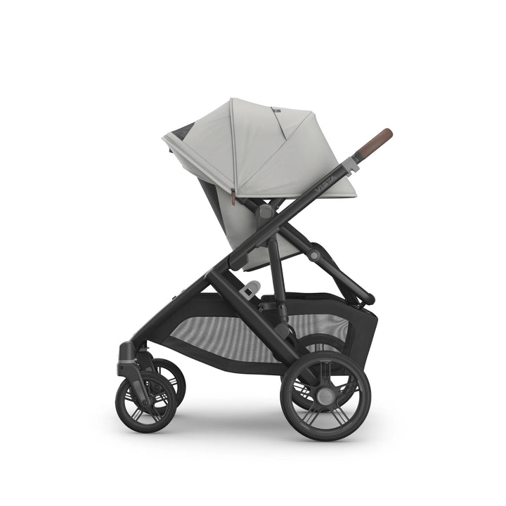 UPPAbaby Vista V3 Savannah stroller side view featuring light grey toddler seat fully extended canopy, adjustable recline, large all-terrain wheels, leather handlebar, and oversized storage basket on premium charcoal frame.