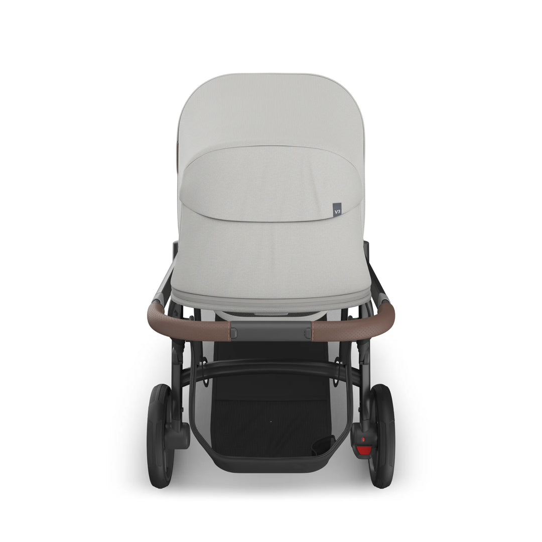 Front-facing view of UPPAbaby Vista V3 Savannah bassinet stroller in light grey with full canopy, leather handlebar, large storage basket, and all-terrain wheels on white background.