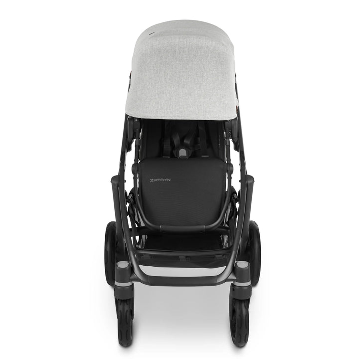Front view of UPPAbaby Vista V2 Anthony pushchair in light grey fabric with black frame and brown leather handle, featuring extended canopy, five-point harness, and large underseat storage basket — premium baby stroller for everyday adventures.