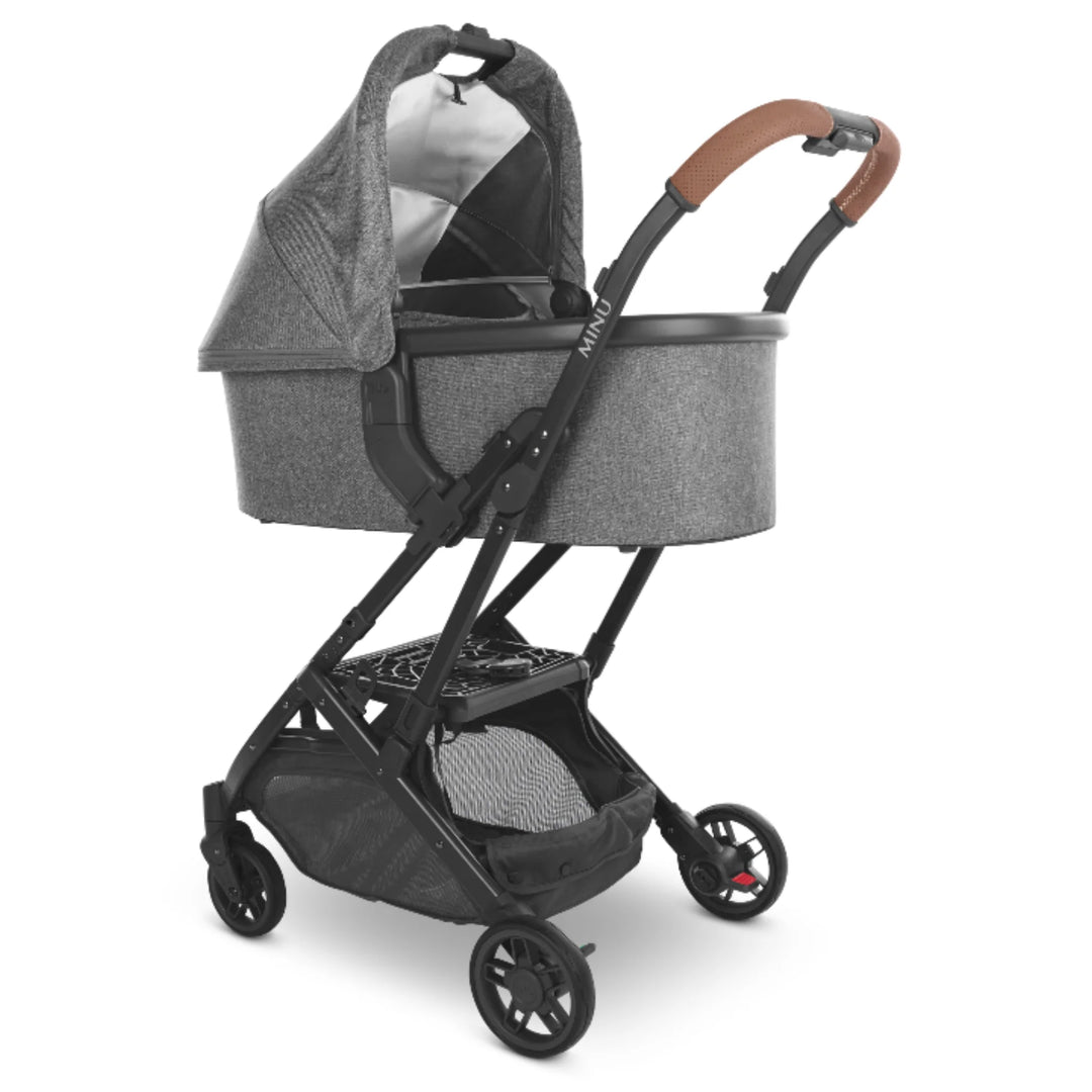 UPPAbaby MINU V2 stroller with carrycot attached using carrycot adapters, grey bassinet on black frame with leather handlebar