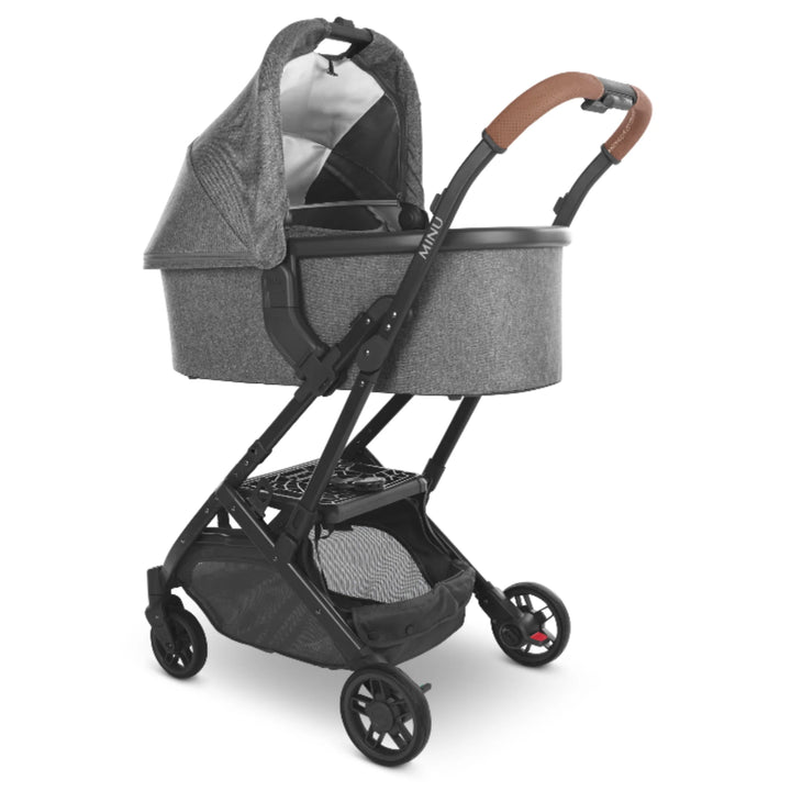UPPAbaby MINU V2 stroller with carrycot attached using carrycot adapters, grey bassinet on black frame with leather handlebar