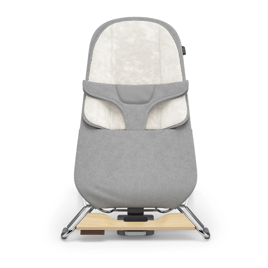 UPPAbaby Mira Bouncer in Stella grey shown front-facing on a white background, featuring plush newborn insert, breathable mesh support panel, ergonomic infant harness, and modern lightweight frame with natural wood base accent.