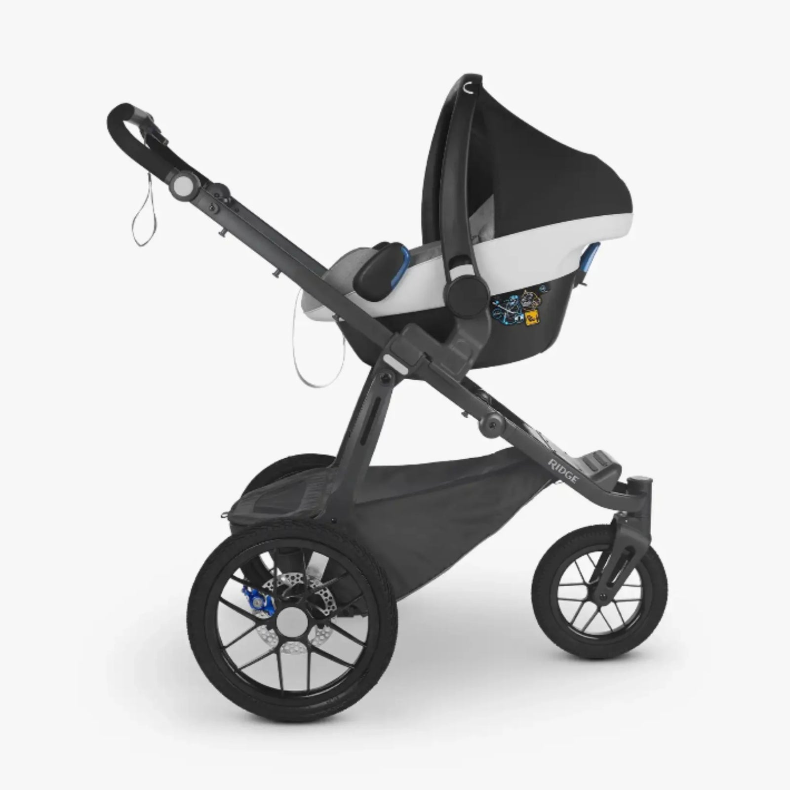 UPPAbaby RIDGE stroller with infant car seat fitted using Maxi-Cosi/Nuna/Cybex/Besafe car seat adapters, side view on white background
