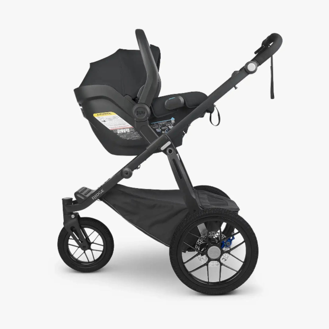 UPPAbaby RIDGE all-terrain stroller with UPPAbaby MESA car seat fitted via adapter set.”