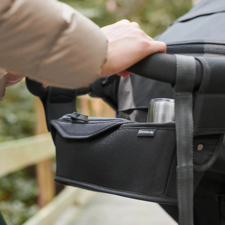 UPPAbaby RIDGE Parent Console stroller organiser attached to handlebar with cup holder and zip pocket, shown in use outdoors