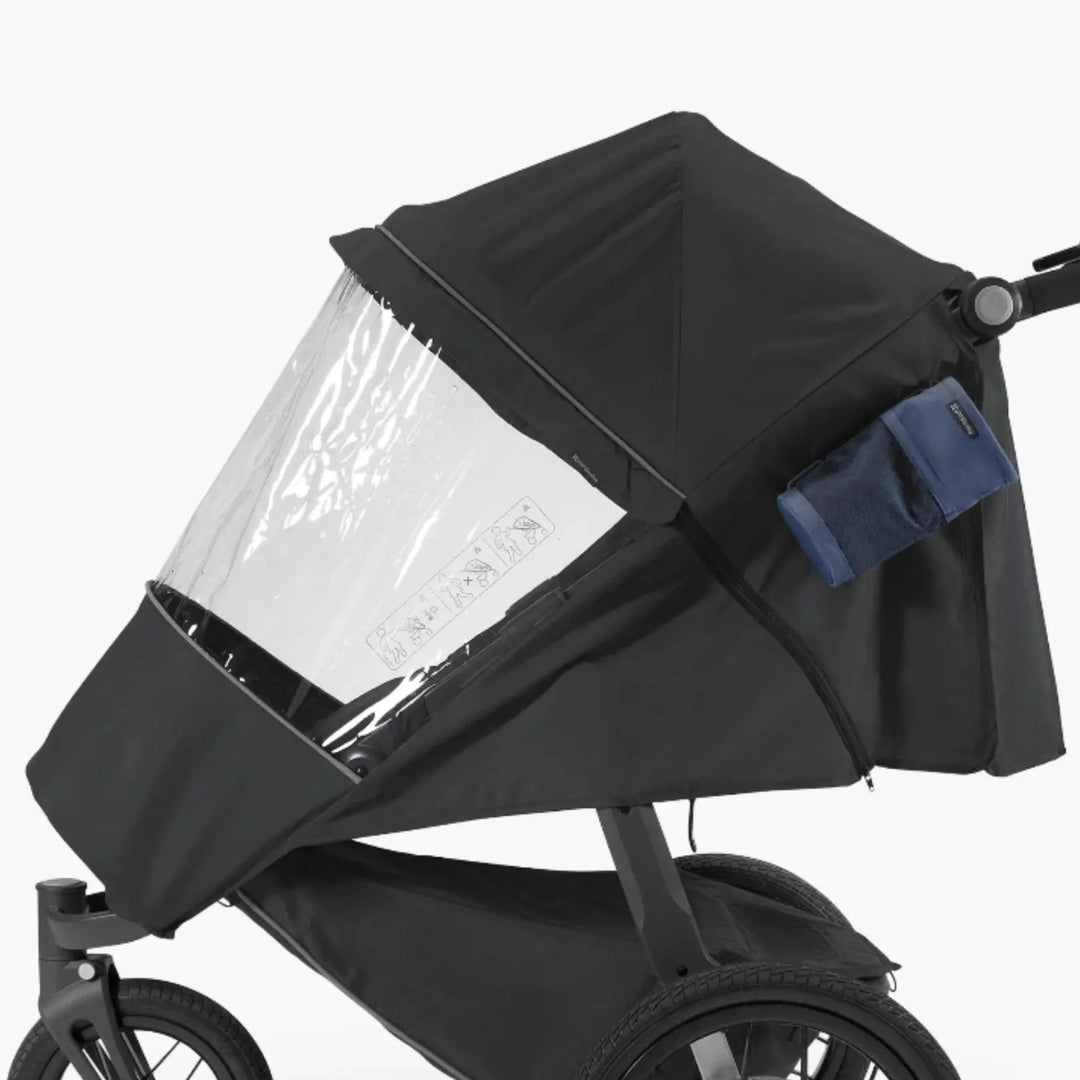 UPPAbaby RIDGE Performance Rain Shield fitted to stroller, clear waterproof zip-on cover with canopy for all-weather protection.