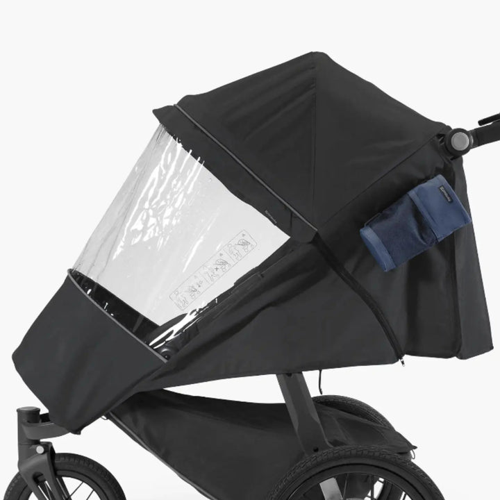 UPPAbaby RIDGE Performance Rain Shield fitted to stroller, clear waterproof zip-on cover with canopy for all-weather protection.